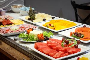 a buffet with several plates of food on a table at Hotel Bahia do Sol in Salvador