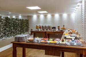 a buffet line with many different types of food at Hotel Bahia do Sol in Salvador