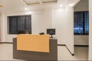 an office with a desk with a computer on it at Sakthi Grand in Erode
