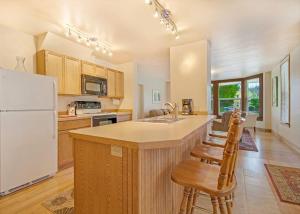a kitchen with a large island with a white refrigerator at Peter Jensen House in Friday Harbor