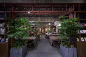 a restaurant with tables and potted plants in it at Matsumoto Jujo in Matsumoto +83 photos