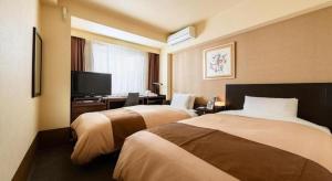 a hotel room with two beds and a television at Hotel Sealuck Pal Kofu in Showa +122 photos