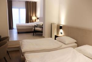 a room with three beds in a hotel room at Rooms Vodisek - Depandansa Hotela Capris Capodistria Boutique in Koper