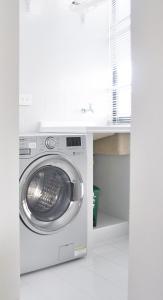 a washing machine in a kitchen with a counter at Alto 61 Apartamentos in Bogotá