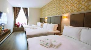 Postel nebo postele na pokoji v ubytování Tropicana Boutique Hotel + 191 fotografií