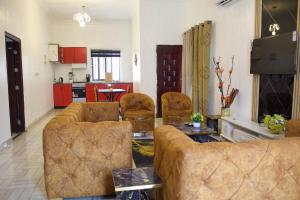 a living room with two couches and a kitchen at ftrealtyproperties Lords Hill 13 in Tokuse