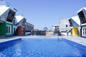 a swimming pool in the middle of a street with houses at ftrealtyproperties Lords Hill 13 in Tokuse
