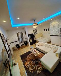 a living room with a couch and a table at ftrealtyproperties Lords Hill in Tokuse