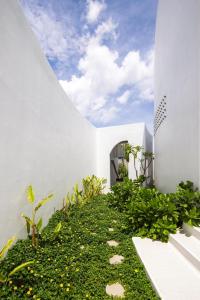 une maison blanche avec un jardin sur le côté dans l'établissement iSea Resort, à Ba Ha 54 autres photos