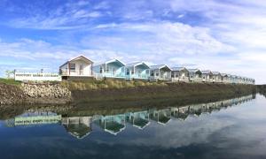 a row of houses next to a body of water at Westport Marina Cottages in Westport