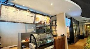 a fast food restaurant with a menu on the wall at HOTEL SARI KURING INDAH in Cilegon