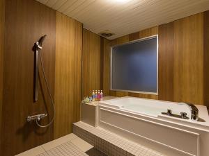 a large bathroom with a tub and a shower at HOTEL PARIET Nakagawa - Adult Only in Fukuoka +25 photos