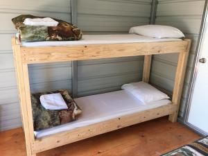 a couple of bunk beds in a room at Lupine Cabin, Glamour Camping, Stunning Skies and Sunrise Views in Monticello