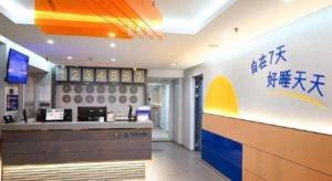 a fast food restaurant with a counter with writing on the wall at 7 Days Inn Shenyang Gugong Middle Street Pedestrian Street in Shenyang