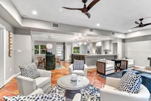 a living room with couches and a dining room at Beach Walk Cottage - 451 in Siesta Key