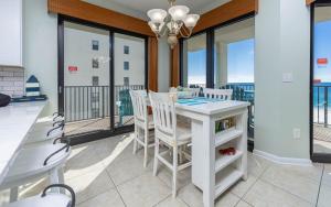 a dining room with a table and chairs on a balcony at Phoenix VI 61115 in Orange Beach