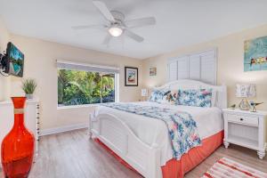a bedroom with a white bed and a window at La Contento Casa - 5560 in Siesta Key +57 photos