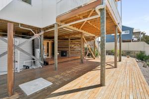 une maison construite avec une terrasse en bois dans l'établissement Scarp n Sea, Sauna Views & Serene Coastal Comfort, à Falcon