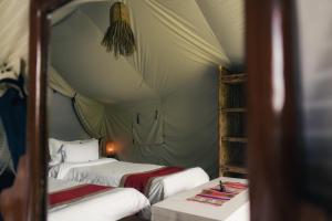 a bedroom with two beds in a tent at Know About Destinations in Kathmandu