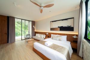 a bedroom with two beds and a ceiling fan at Sawo Villa Canggu - Private Brand New 2BR Villa in Canggu