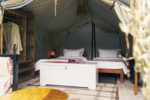 a bedroom with two beds in a tent at Know About Destinations in Kathmandu