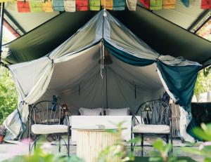 a tent with two chairs and a table in it at Know About Destinations in Kathmandu
