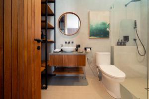 a bathroom with a sink and a toilet and a mirror at Sawo Villa Canggu - Private Brand New 2BR Villa in Canggu +22 photos