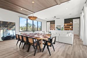 a dining room and living room with a table and chairs at Point of Paradise - 7007 in Sarasota