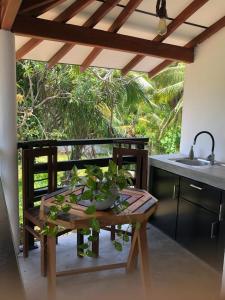 a kitchen with a table with a plant on it at Villa Ranuka in Unawatuna