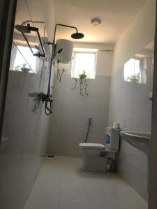 a bathroom with a toilet and a sink and a window at Villa Ranuka in Unawatuna