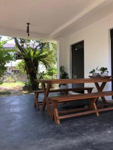 a wooden picnic table in a room with a tree at Villa Ranuka in Unawatuna