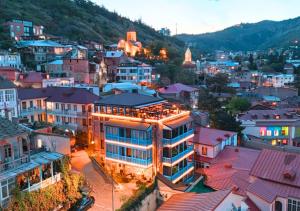 a view of a city at night with buildings at TbiliSee Hotel in Tbilisi City