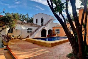 a backyard with a swimming pool and a house at La Cortijera in Benidoleig