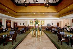 a dining room with tables and chairs in a restaurant at Waterfront Airport Hotel and Casino in Mactan