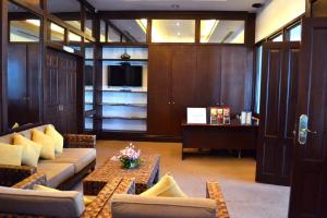 a lobby with couches and a table and a tv at Waterfront Airport Hotel and Casino in Mactan