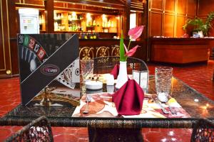 a table with a vase with a flower on it at Waterfront Airport Hotel and Casino in Mactan