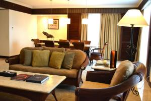 a living room with a couch and a table at Waterfront Airport Hotel and Casino in Mactan