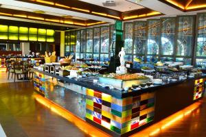 a buffet line in a hotel with food on display at Waterfront Airport Hotel and Casino in Mactan