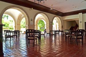 a row of tables and chairs in a room with arches at Waterfront Airport Hotel and Casino in Mactan