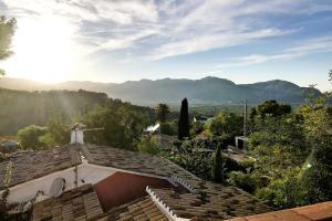 a woman standing on the roof of a house at La Cortijera in Benidoleig
