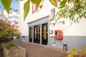 a facade of a building with black doors and windows at Villa Diana WestEnd in Frankfurt