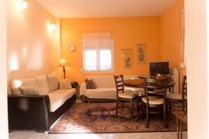 a living room with a couch and a table at Adam's House in Tríkala