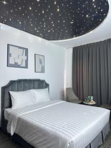 a bedroom with a large bed with a star ceiling at Boutique Hotel in Hanoi +31 photos