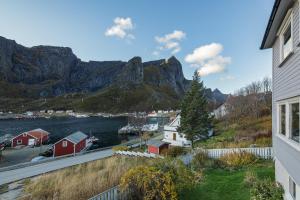 a view of the water and mountains from a house at Valen Retro Home, Reine in Reine