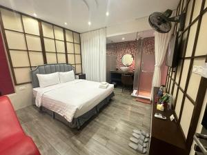 a bedroom with a bed and a desk in a room at Boutique Hotel in Hanoi