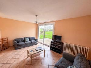 a living room with a couch and a table at Grande maison 5 chambres 25 min du Parc in Chavagnes-les-Redoux