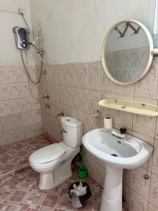 a bathroom with a toilet and a sink and a mirror at Backpacker Galle Hostel in Galle +76 photos