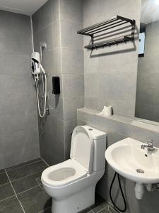 a bathroom with a toilet and a sink at Sunshine Residence in Ayer Itam