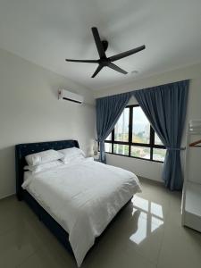 a bedroom with a bed with a ceiling fan at Sunshine Residence in Ayer Itam +16 photos