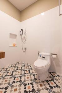 a bathroom with a toilet and a tiled floor at Jacuzzi mine hills in Ban Mai +26 photos